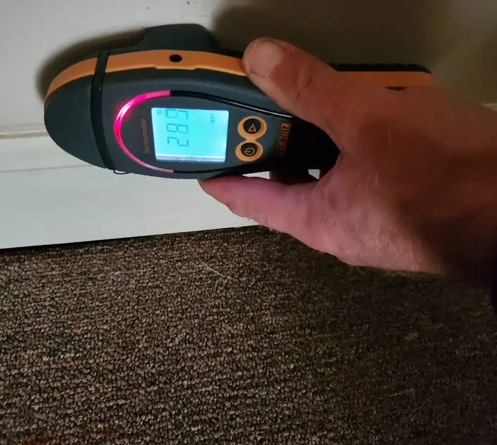Moisture detection at baseboard during Storm Damage Restoration in Ocean Pines